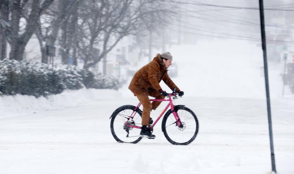  A man braves the snow and bitter cold for a bike ride along Katonah Avenue in downtown Katonah during steady snowfall Jan. 29, 2022. 