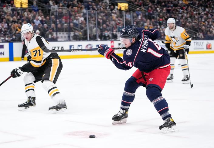 Columbus Blue Jackets center Gustav Nyquist (14) whiffs on the first shot but followed it with a goal as he skates past Pittsburgh Penguins center Evgeni Malkin (71) during the first period of the NHL hockey game at Nationwide Arena in Columbus on Friday, Jan. 21, 2022. 