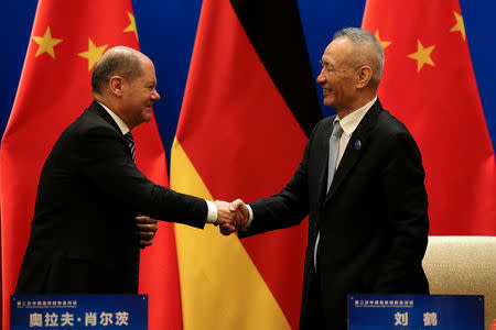 German Finance Minister Olaf Scholz shakes hands with Chinese Vice Premier Liu He after attending a signing ceremony for the China-Germany High Level Financial Dialogue at the Diaoyutai State Guesthouse in Beijing, China, January 18, 2019. Andy Wong/Pool via Reuters