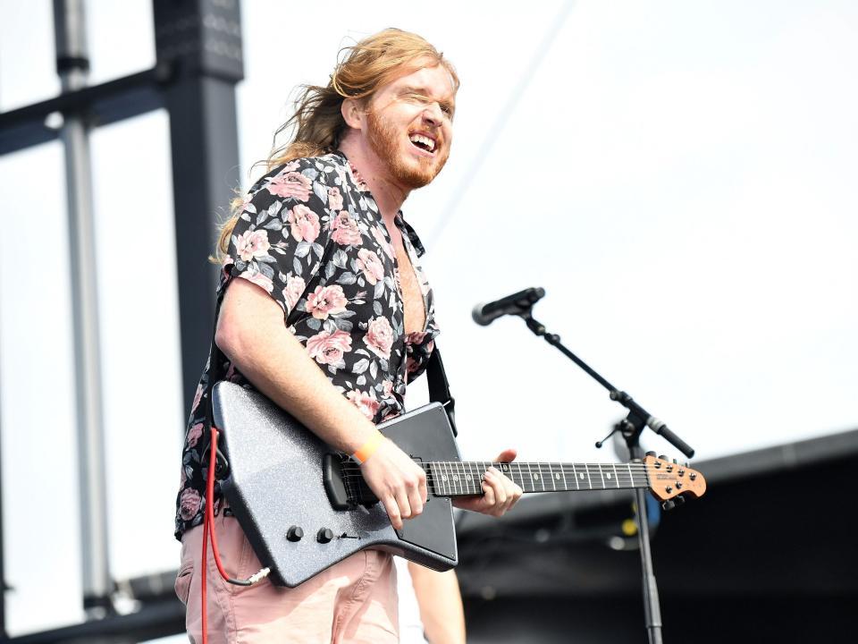 Trevor Lukather performs onstage in a patterned shirt in 2018.