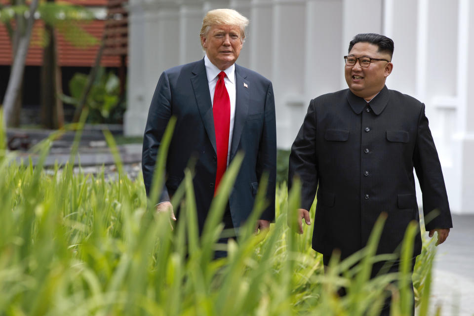 FILE - In this June 12, 2018 file photo, President Donald Trump walks with North Korean leader Kim Jong Un on Sentosa Island, in Singapore. South Korea’s liberal President Moon Jae-in faces growing skepticism at home about his engagement policy ahead of his third summit with North Korean leader Kim Jong Un. A survey showed nearly half of South Koreans think next week’s summit won’t find a breakthrough to resolve a troubled nuclear diplomacy. It comes as Moon’s approval rating is declining amid economic frustrations.(AP Photo/Evan Vucci, File)