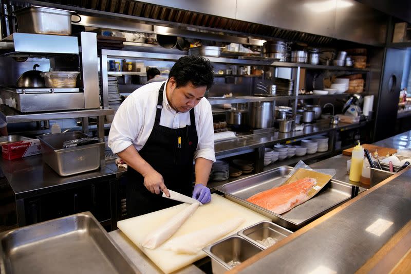 Chef and owner Austin Hu prepares frozen cod fish and salmon at Heritage by Madison restaurant, in Shanghai