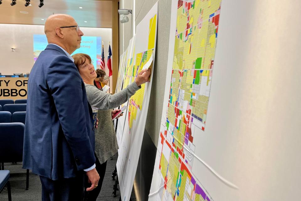 Lubbock City Councilman Mark McBrayer and Tech Terrace U.N.I.T. neighborhood association President Cyndi Pratas discuss a proposed zoning map during a public hearing at Citizens Tower March 22.