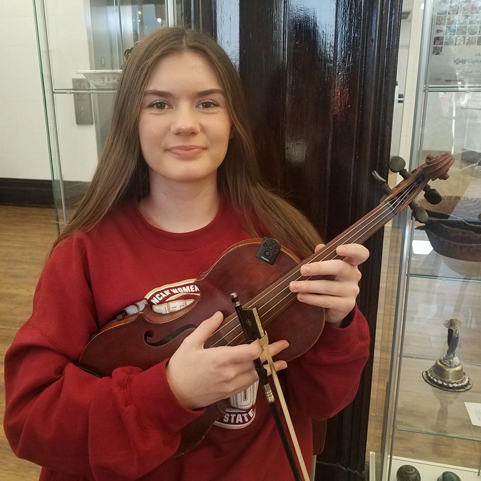 Katy Hill, 15, poses with her violin at the Tallahassee Senior Center on Jan. 18, 2024.