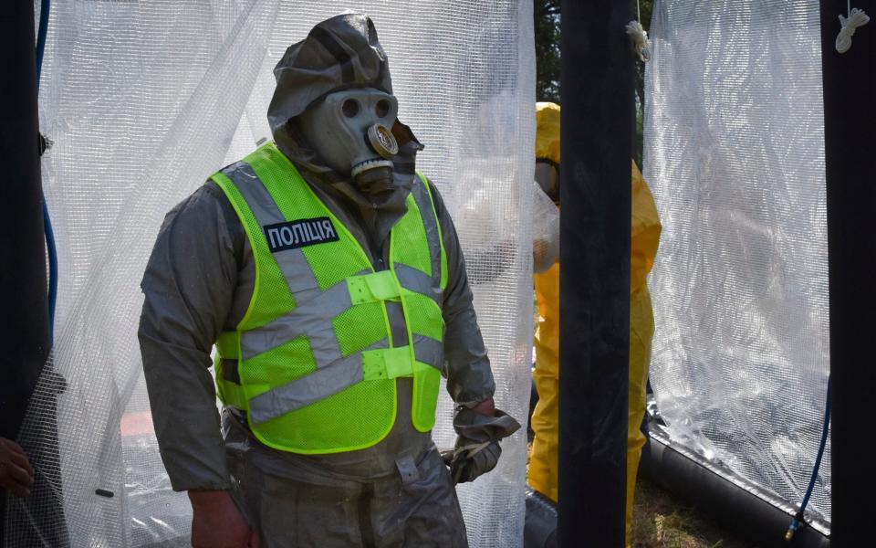 Ukrainian emergency workers wearing radiation protection suits attend training in Zaporizhzhia - Andriy Andriyenko/AP