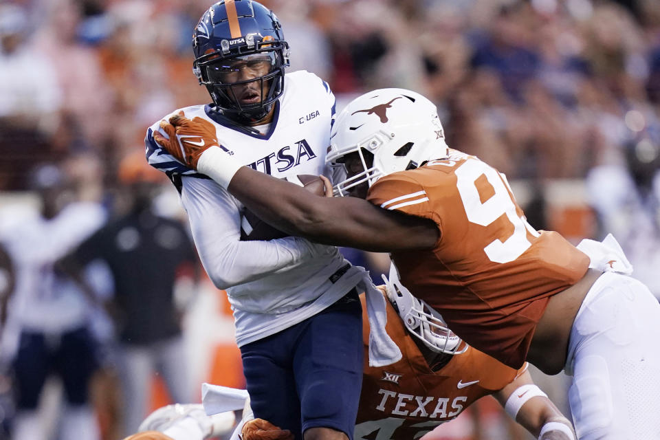 UTSA quarterback Frank Harris, left, is hit by Texas defensive lineman Alfred Collins (95) during the first half of an NCAA college football game, Saturday, Sept. 17, 2022, in Austin, Texas. (AP Photo/Eric Gay)