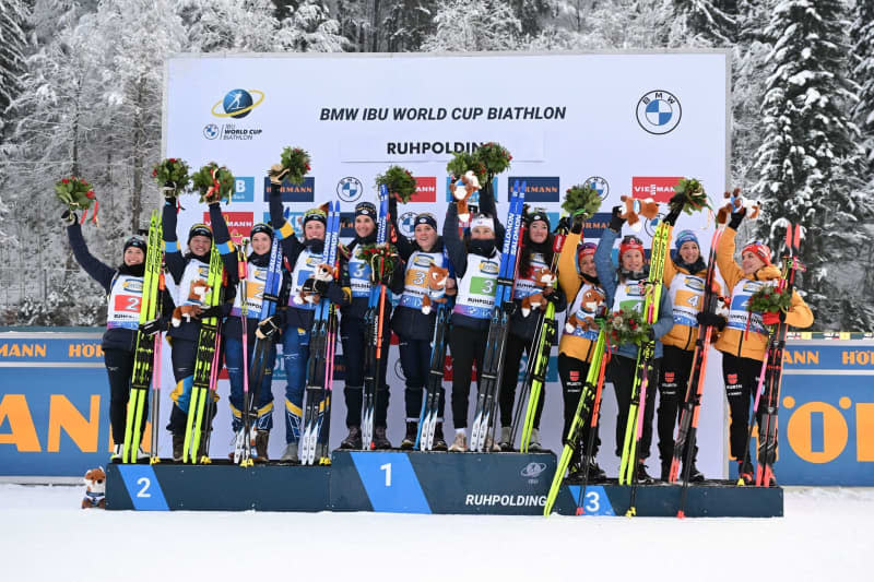 (L-R) Sweden's second-placed team, France's winning team and the Germany's third-placed team celebrate on the podium after the Women's 4x6 km relay competition of the Biathlon World Cup in Ruhpolding. Sven Hoppe/dpa