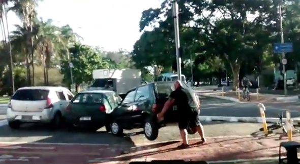 Brilliant moment huge cyclist moves car out of bike lane with bare hands (video)