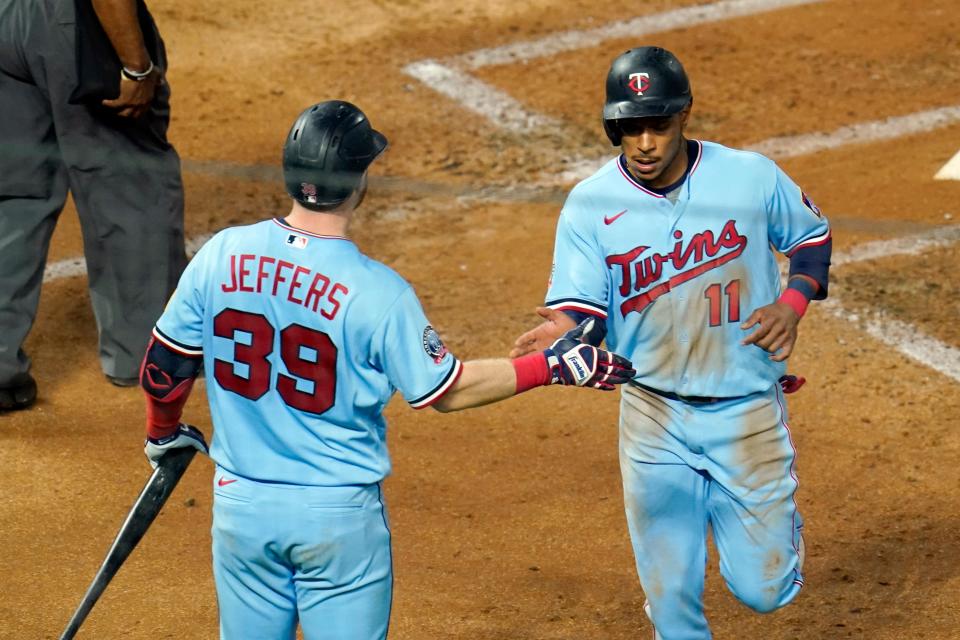 Minnesota Twins' Jorge Polanco, right, is greeted by Ryan Jeffers after Polanco scored on a single by Marwin Gonzalez off Detroit Tigers pitcher Casey Mize during the third inning of a baseball game, Wednesday, Sept. 23, 2020, in Minneapolis.