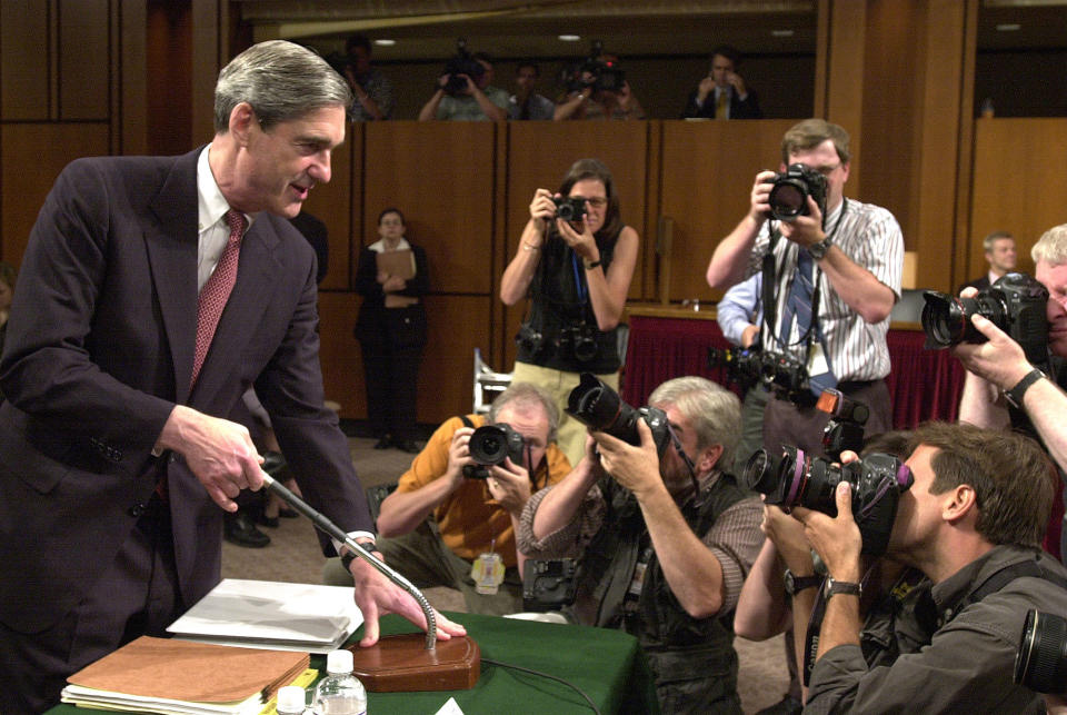 <p>Photographers gather around FBI Director Robert Mueller as he appears before the Senate Judiciary Committee on Capitol Hill Thursday, June 6, 2002. The committee is conducting an oversight hearing on counterterrorism. (Photo: Dennis Cook/AP) </p>