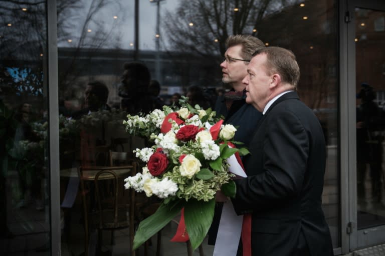 Danish Prime Minister Lars Lokke Rasmussen (R) and Mayor of Copenhagen Frank Jensen lay flowers at Krudttonden on February 14, 2016 in memory of Finn Norgaard