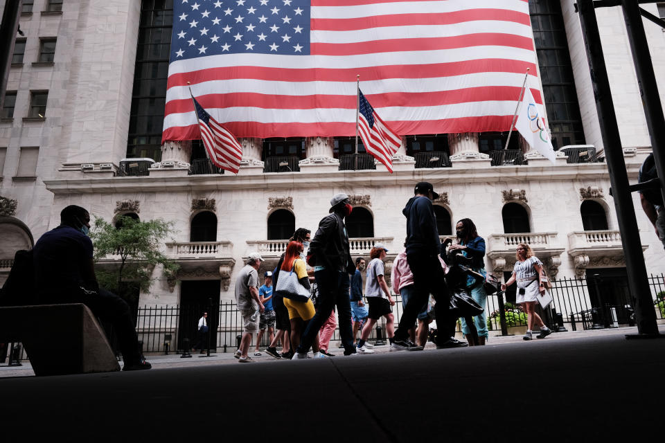 NEW YORK, NEW YORK - AUGUST 10: People walk by the New York Stock Exchange (NYSE) on August 10, 2021 in New York City. Markets were up in morning trading as investors look to a rare bipartisan effort in the Senate to pass a massive infrastructure bill that, if passed, will infuse billions into the American economy. (Photo by Spencer Platt/Getty Images)