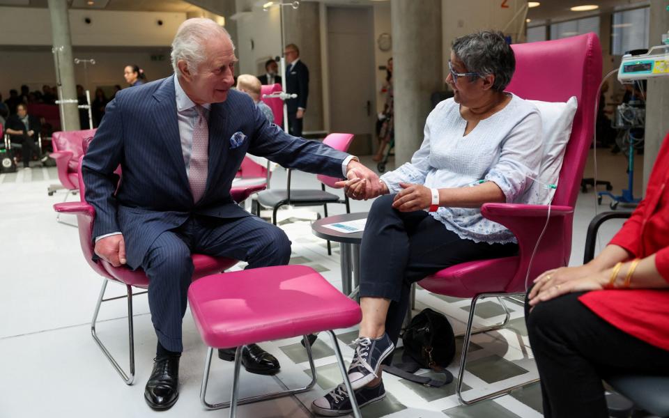 Charles comforts Asha Millan on his visit to the University College Hospital Macmillan Cancer Centre