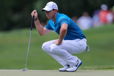 May 17, 2015; Charlotte, NC, USA; Rory McIlroy looks over his line on five green during the final round at Quail Hollow Club. Mandatory Credit: Jim Dedmon-USA TODAY Sports