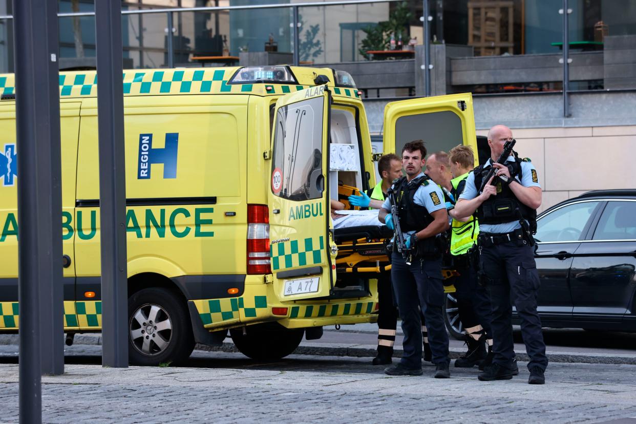 An ambulance and armed police outside the Field's shopping center, in Orestad, Copenhagen, Denmark, Sunday, July 3, 2022, after reports of shots fired. 