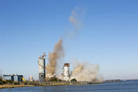 The smokestack at the former B.L. England Generating Station, a coal and oil burning power plant in Upper Township, N.J., is toppled during a control demolition on Thursday, October 26, 2023. The site will be redeveloped as a mixed-use residential and commercial project, and a nearby electrical substation will be used to connect New Jersey's soon-to-come offshore wind farms with the electrical grid. (AP Photo/Ted Shaffrey)