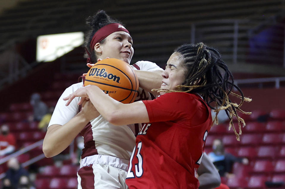 Boston College guard Makayla Dickens and Louisville guard Chelsie Hall (23) vie for a rebound during the second half of an NCAA college basketball game, Sunday, Jan. 16, 2022, in Boston. (AP Photo/Mary Schwalm)