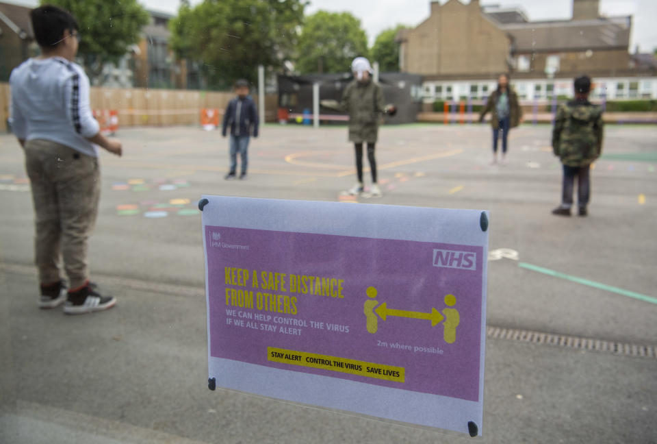 LONDON, ENGLAND - JUNE 10: Children maintain social distancing measures while playing in the playground at Earlham Primary School, which is part of the Eko Trust on June 10, 2020 in London, England. As part of Covid-19 lockdown measures, Earlham Primary School is teaching smaller ‘bubbles’ of students, to help maintain social distancing measures. School staff have put into place many safety measures such as corridor signage for a one way system, regular supervised handwashing, temperature checks on arrival and enhanced cleaning regimes to keep pupils and staff as safe as possible. Bubbles of pupils are limited to six and each have their own well-ventilated space. The Government have announced it is set to drop plans for all English primary pupils to return to school before the end of the summer. (Photo by Justin Setterfield/Getty Images)