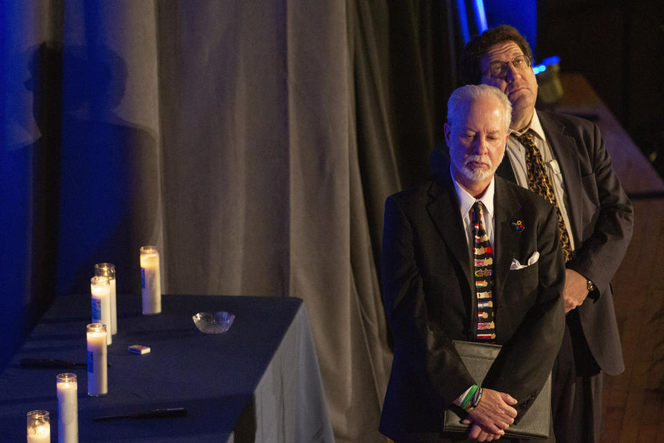 FILE - In this Sunday, Oct. 27, 2019 file photo, Rabbis Jeffrey Myers, left, of Tree of Life/Or L'Simcha Congregation and Jonathan Perlman of New Light Congregation wait on stage before speaking to standing-room only crowd gathered for the one-year commemoration of the Tree of Life synagogue attack, at Soldiers & Sailors Memorial Hall and Museum in Pittsburgh. Since March 2020, Tree of Life has halted all in-person worship and group activities. However, Rabbi Myers has made appearances on Zoom and Facebook, livestreamed from his living room. “During the pandemic, people are seeking community,” he said. “We try in any way to help them find solace and hope and inspiration.” (AP Photo/Rebecca Droke)