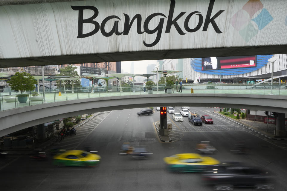 Vehicles run on the road under the "Bangkok" signage on the sky train track in Bangkok,Thailand, Thursday, Feb. 17, 2022. After some confusions, the Royal Society issued a clarification explaining: “Writing the capital city’s official name with the Roman alphabet can be done both as Krung Thep Maha Nakon and Bangkok.” (AP Photo/Sakchai Lalit)