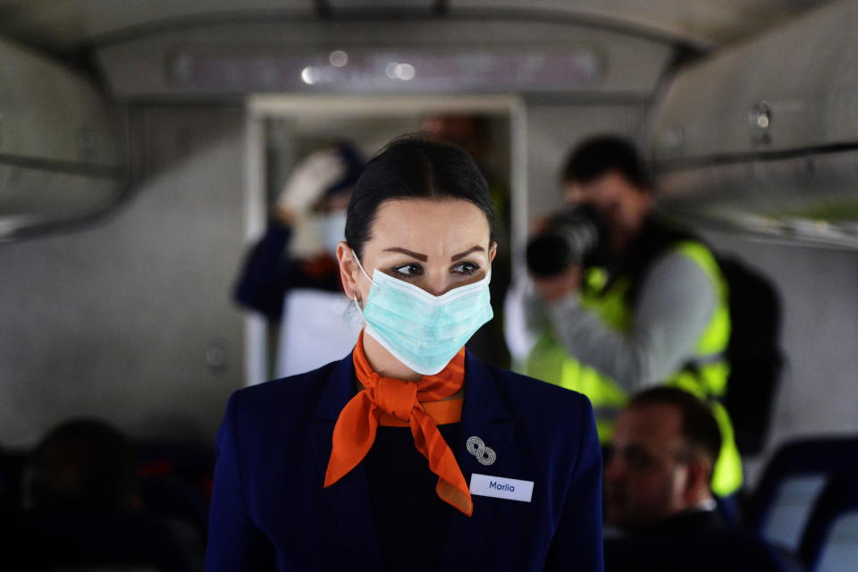 Put on your mask first before assisting others.&nbsp; (Photo: Yuri Smityuk via Getty Images)