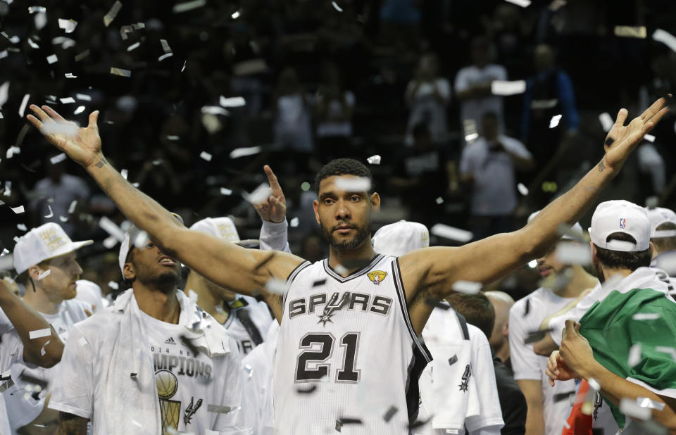 FILE - In this June 15, 2014, file photo, San Antonio Spurs forward Tim Duncan (21) celebrates after Game 5 of the NBA basketball finals in San Antonio. Kobe Bryant, Tim Duncan and Kevin Garnett. Each was an NBA champion, an MVP, an Olympic gold medalist, annual locks for All-Star and All-Defensive teams. And now, the ultimate honor comes their way: On Saturday night, May 15, 2021, in Uncasville, Connecticut, they all officially become members of the Naismith Memorial Basketball Hall of Fame. (AP Photo/David J. Phillip, File)