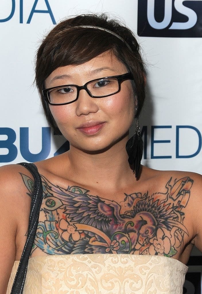 An Asian woman with tattoos