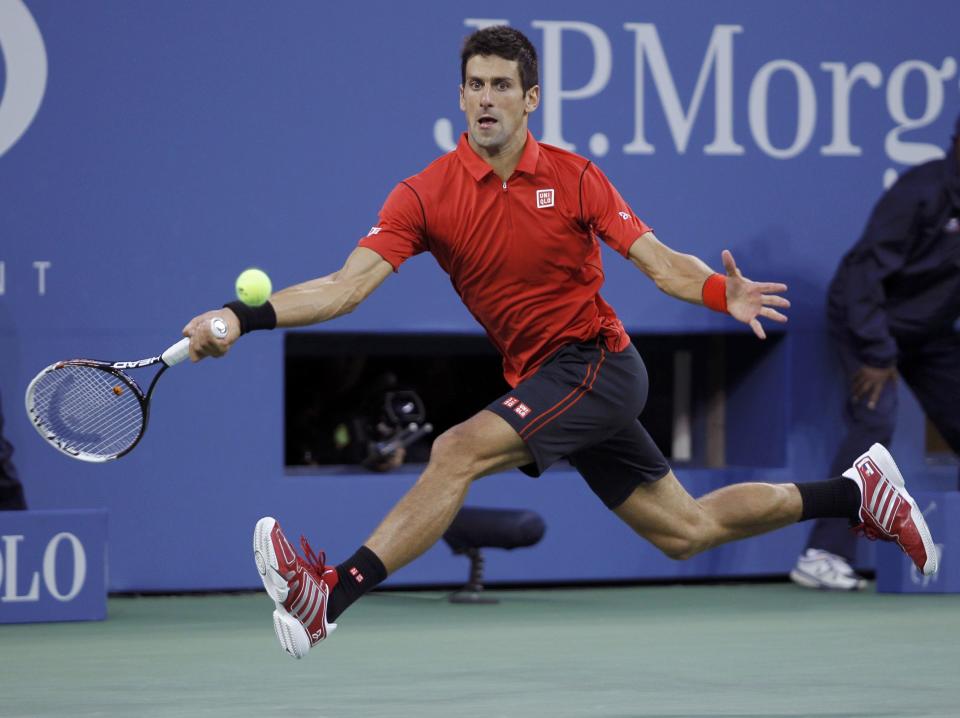 Novak Djokovic of Serbia hits a return to Rafael Nadal of Spain during their men's final match at the U.S. Open tennis championships in New York, September 9, 2013. REUTERS/Kena Betancur (UNITED STATES - Tags: SPORT TENNIS)