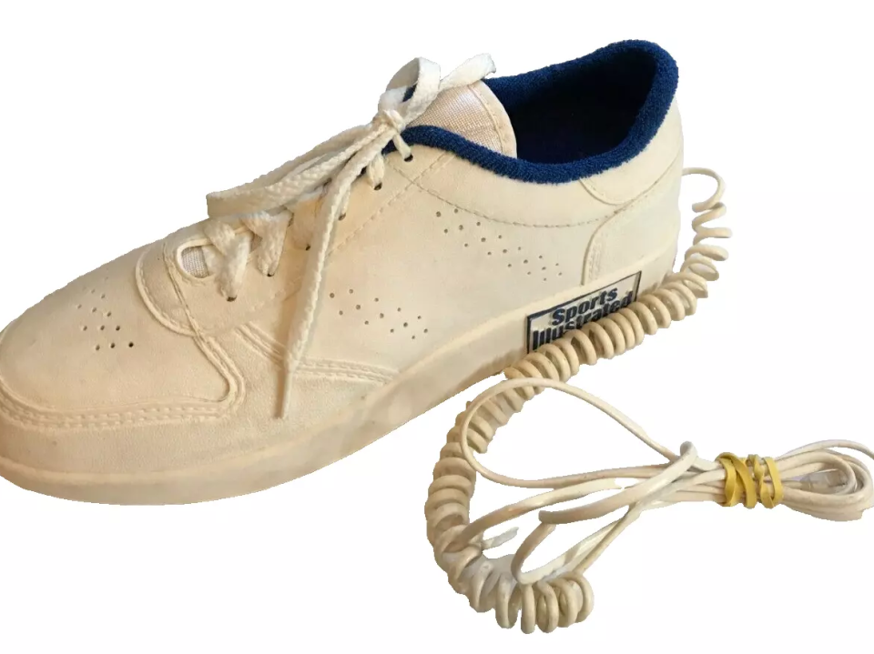 A vintage-style sneaker with a coiled phone cord in place of a shoelace