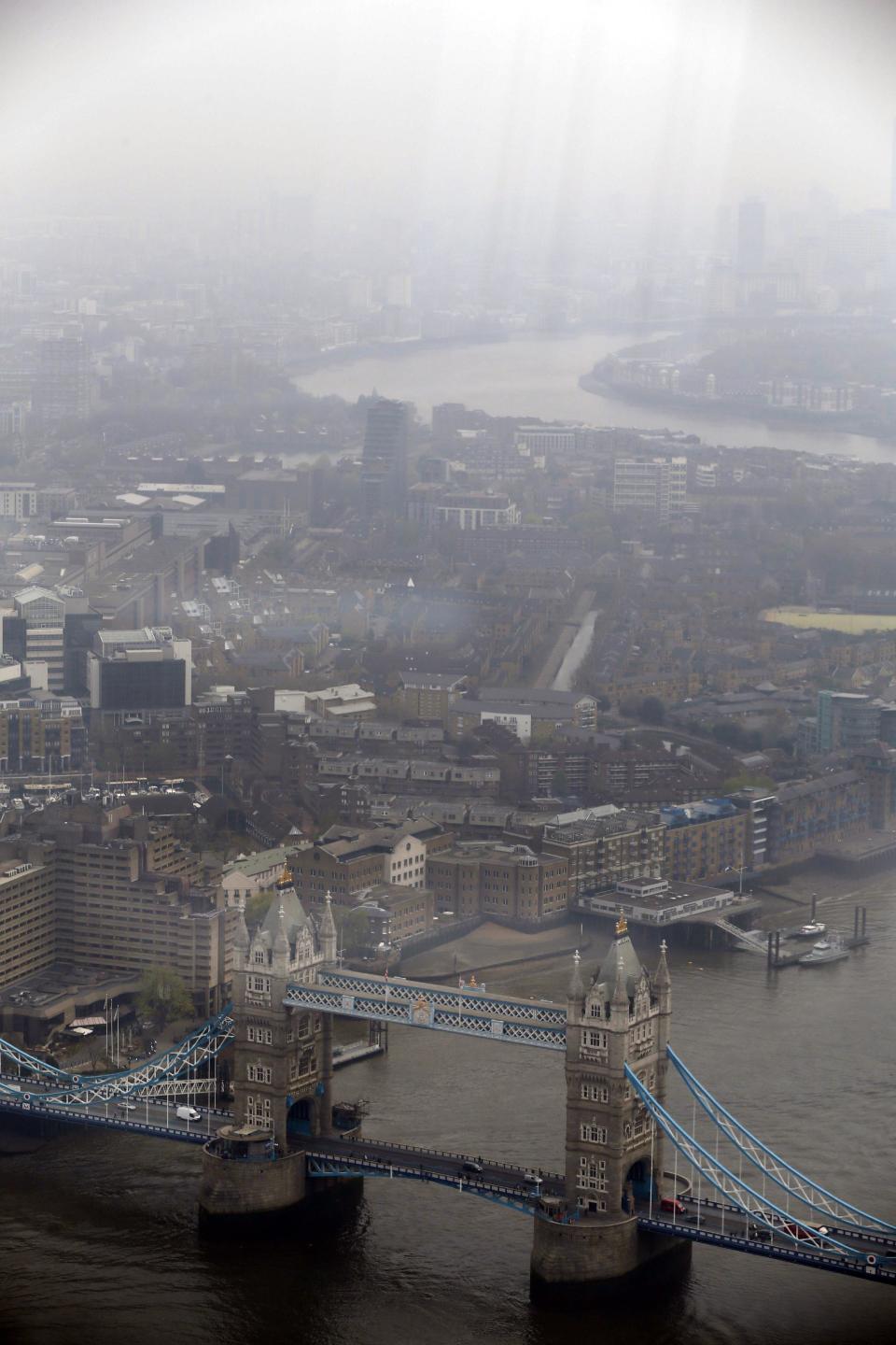 A view of the Tower Bridge on the river Thames in central London, Thursday, April 3, 2014. British authorities have warned people with heart or lung conditions to avoid exertion as a combination of industrial pollution and Sahara dust blankets the country in smog. The environment department said air pollution level could reach the top rung on its 10-point scale. The pollution is expected to ease by Friday. (AP Photo/Lefteris Pitarakis)