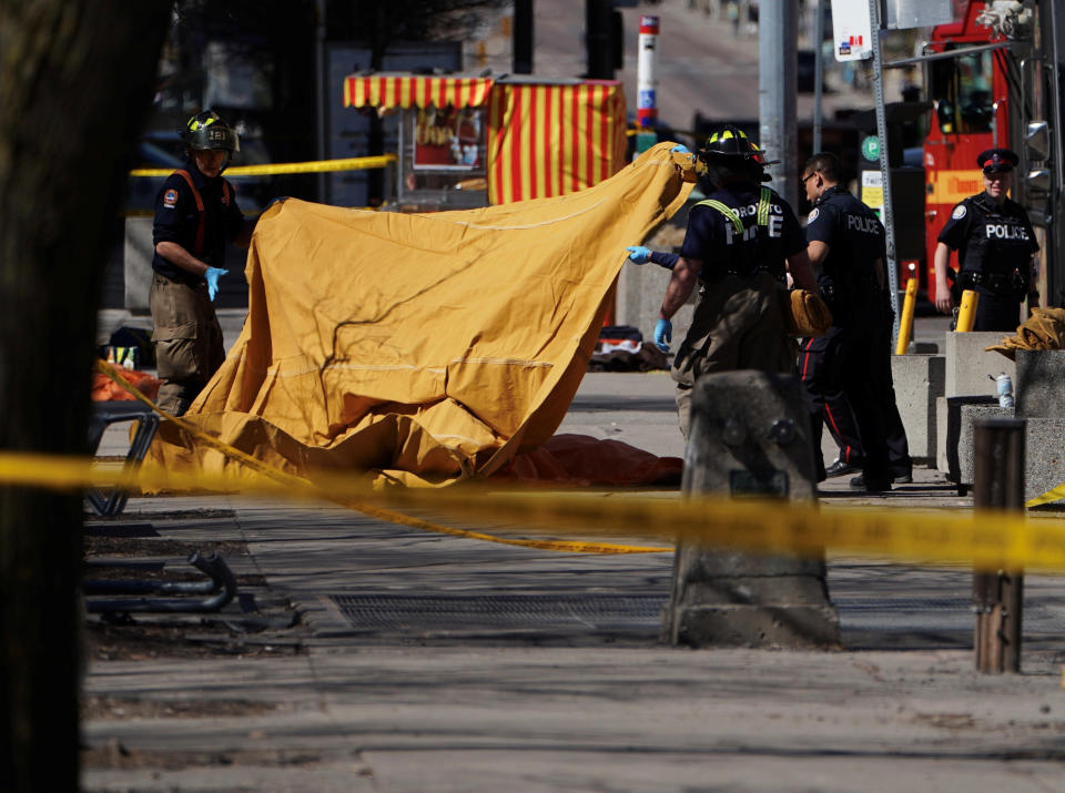 Firemen cover a victim.&nbsp;