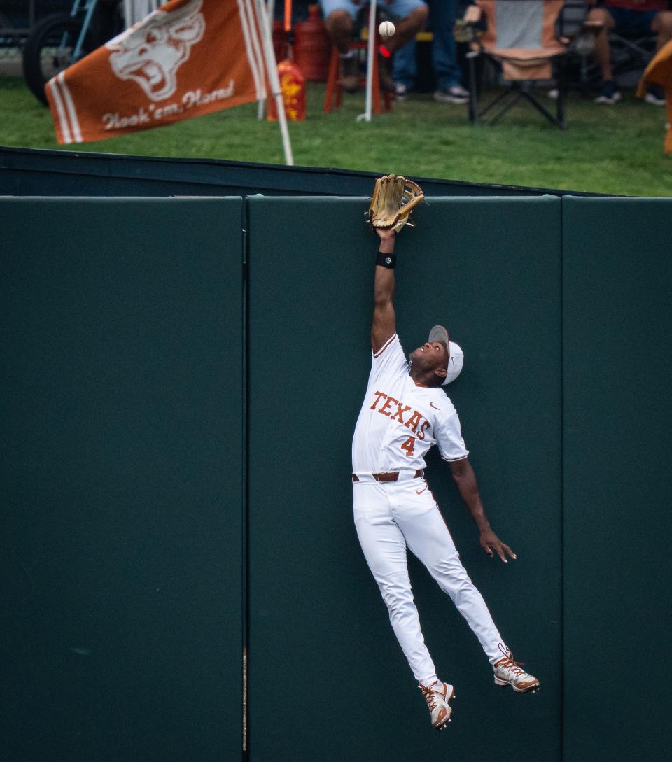 Texas outfielder Porter Brown tries to catch a ball that would fall just over the fence in the first inning of Tuesday night's 17-9 loss to UT-Rio Grande Valley at UFCU Disch-Falk Field. The Longhorns had won the previous 48 meetings with the Vaqueros dating back to 1971.