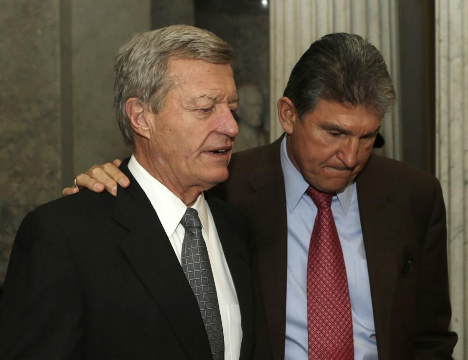 Senators Baucus and Manchin walk out of Senate chamber after budget vote on Capitol Hill in Washington