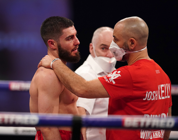 Josh Kelly is comforted by trainer Adam BoothDave Thompson