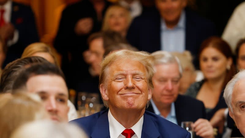 Republican presidential candidate former President Donald Trump, center, at Trump International Golf Course in West Palm Beach, Fla., Sunday, March 24, 2024.