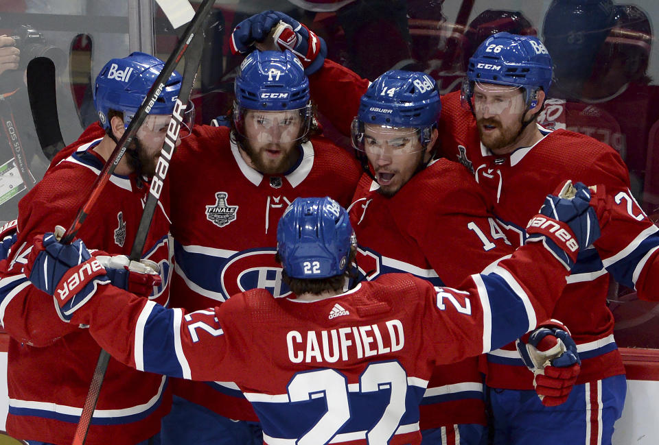 Montreal Canadiens' Josh Anderson (17) celebrates his goal against the Tampa Bay Lightning with teammates Joel Edmundson (44), Cole Caufield (22), Nick Suzuki (14) and Jeff Petry (26) during the first period of Game 4 of the NHL hockey Stanley Cup final in Montreal, Monday, July 5, 2021. (Ryan Remiorz/The Canadian Press via AP)