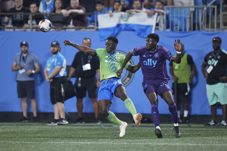 Charlotte FC forward Patrick Agyemang (33) is called for a holding foul against Seattle Sounders defender Yeimar Gómez (28) during an MLS soccer match Saturday, June 10, 2023, in Charlotte, N.C. (AP Photo/Brian Westerholt)