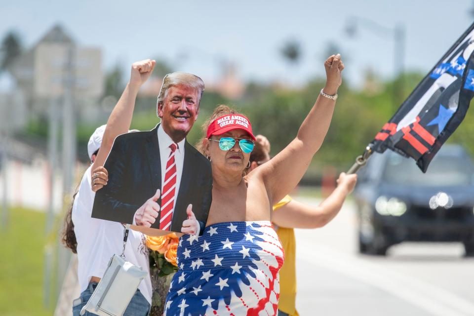 Trump supporter Maria Alexander shows her support Sunday for former President Donald Trump, who was shot in the ear at a campaign rally in Pennsylvania on Saturday night. The supporters gathered near his home at Mar-a- Lago.