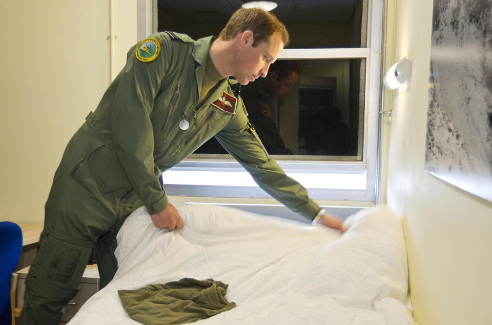 This is an undated handout photo issued by www.dukeanduchessofcambridge.org on Tuesday Nov. 20, 2012 of Britain's Prince William making his bed whilst working as a helicopter search and rescue pilot at RAF Valley on Anglesey, Wales. The picture show a typical "day in the life" for Prince William in his work flying RAF Sea King helicopters from their base at RAF Valley on Anglesey, north Wales. From planning and preparing for any emergency callout to resting with his colleagues during "downtime", the exclusive pictures give an insight into the life of Flight Lieutenant Wales in his day-job as a Search and Rescue (SAR) pilot. (AP Photo/ SAC Faye Storer/MoD, www.dukeanduchessofcambridge.org) NO ARCHIVE EDITORIAL USE ONLY