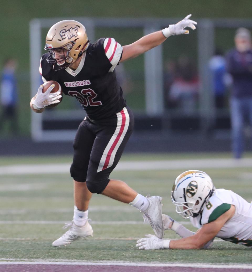 Stow running back Teddy Gregory gets away from Medina safety Zach King on Friday, Sept. 10, 2021 in Stow, Ohio.  [Phil Masturzo/ Beacon Journal] 