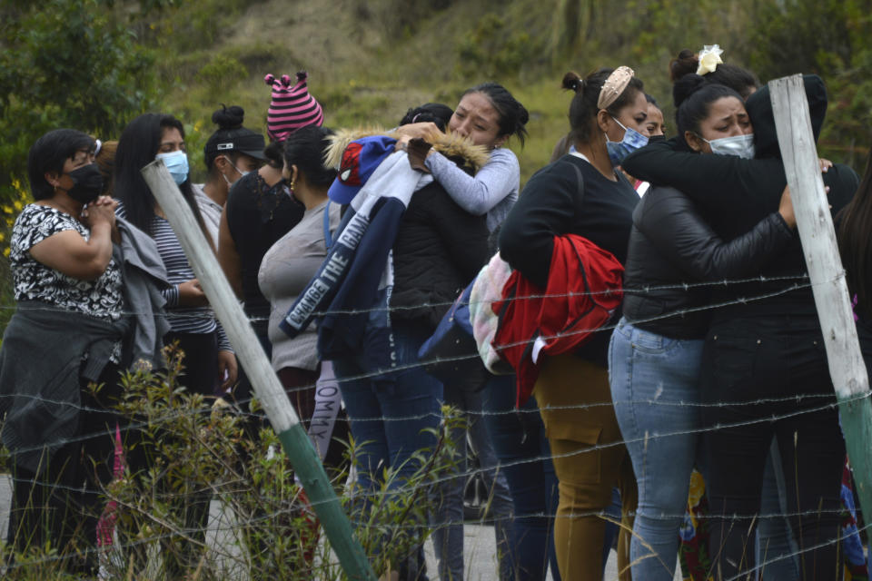 Prisoners' relatives gather outside Turi jail where an inmate riot broke out in Cuenca, Ecuador, Tuesday, Feb. 23, 2021. Deadly riots broke out in prisons in three cities across the country due to fights between rival gangs, according to police. (Boris Romoleroux/API via AP)