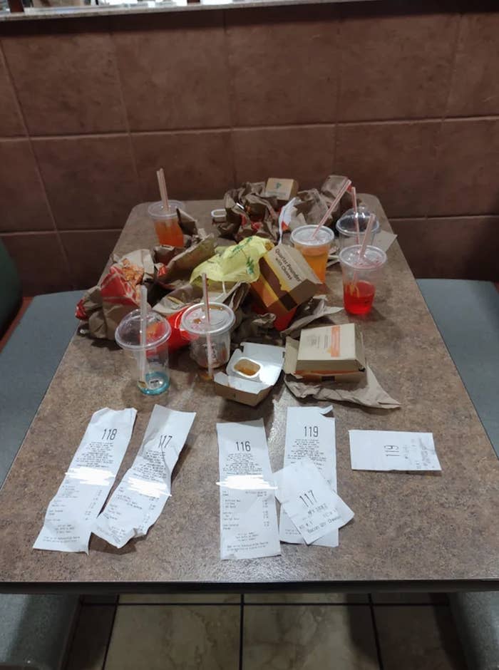 McDonald's food wrappers, drinks, and boxes left as garbage on a table