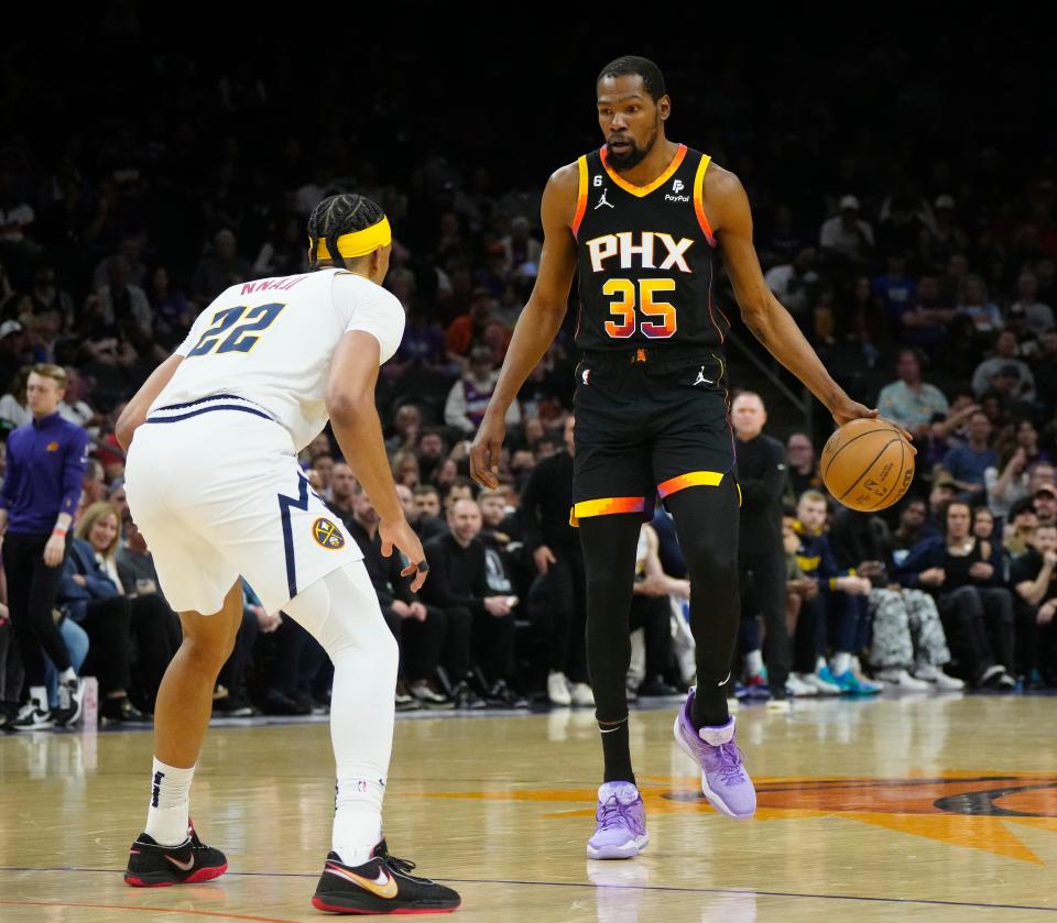 Suns forward Kevin Durant (35) dribbles up the court against Nuggets' Zeke Nnaji (22) during a game at Footprint Center, April 6, 2023.