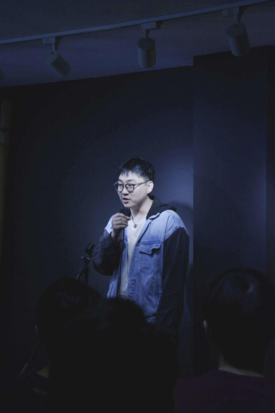 In this photo provided by amateur comedian Zhu Jiesheng, Zhu performs standup, March 25, 2023, in Valencia, Spain. (Courtesy of Zhu Jiesheng via AP)