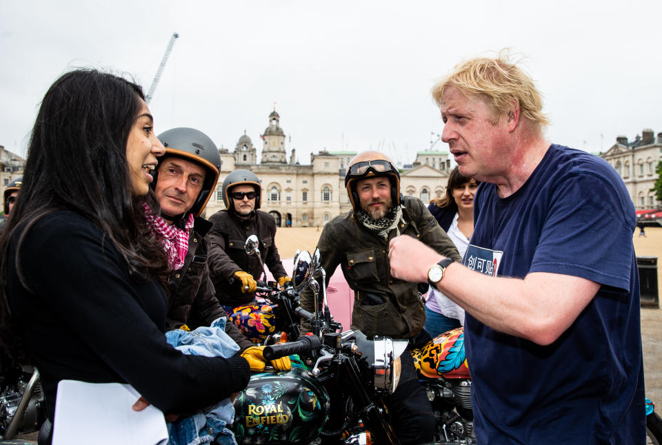 Boris Johnson, Secretary of State for Foreign Affairs chats to Simon de Burton on the House of Hackney bike and Sam Pelly on the Boyarde bike while on Elephant Family's 'Concours d’éléphant’ outside Horse Guards during the photocall in London. PRESS ASSOCIATION Photo. Picture date: Tuesday June 12, 2018. A customised fleet of 12 Ambassador cars, eight Royal Enfield motorbikes, a tuk tuk and a Gujarati Chagda made up the 'Concours d’éléphant’ - a cavalcade of designer inspired, quintessentially Indian vehicles - while thirty beautifully decorated elephant sculptures will stand sentinel across the capital, ambassadors for their cousins in the wild. Boris Johnson, Secretary of State for Foreign Affairs chats to Simon de Burton on the House of Hackney bike and Sam Pelly on the Boyarde bike while on Elephant Family's 'Concours d’éléphant’ outside Horse Guards during the photocall in London. PRESS ASSOCIATION Photo. Picture date: Tuesday June 12, 2018. A customised fleet of 12 Ambassador cars, eight Royal Enfield motorbikes, a tuk tuk and a Gujarati Chagda made up the 'Concours d’éléphant’ - a cavalcade of designer inspired, quintessentially Indian vehicles - while thirty beautifully decorated elephant sculptures will stand sentinel across the capital, ambassadors for their cousins in the wild. 