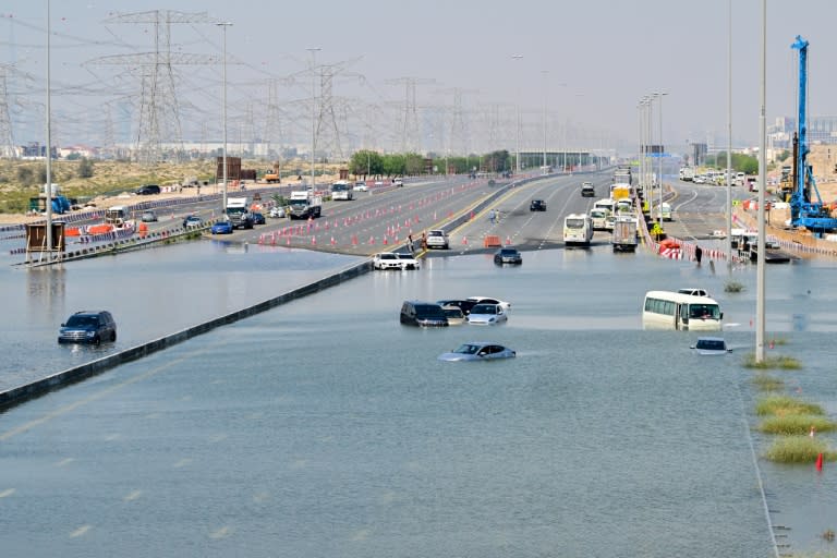 Unos vehículos abandonados en una calle de Dubái inundada como consecuencia de las intensas lluvias, en una imagen del 18 de abril de 2024 (Giuseppe Cacace)