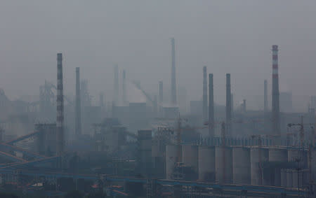 A steel factory is seen in smog during a hazy day in Anshan, Liaoning province, June 29, 2014. REUTERS/Stringer/File Photo