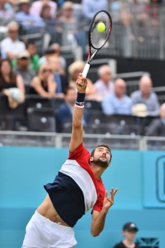 At a stretch: Marin Cilic returns to Gilles Muller as he wins in three sets to reach the Queen's quarter-finals