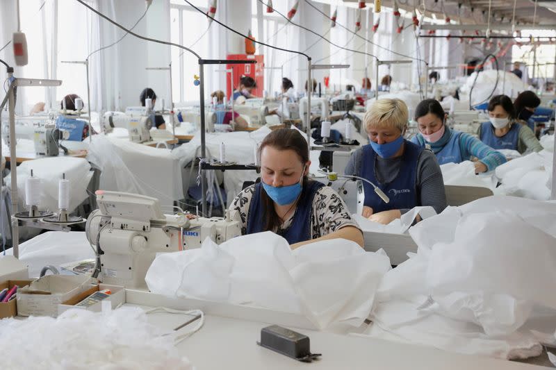 Employees sew protective suits at the Textile-Contact company's factory in Chernihiv