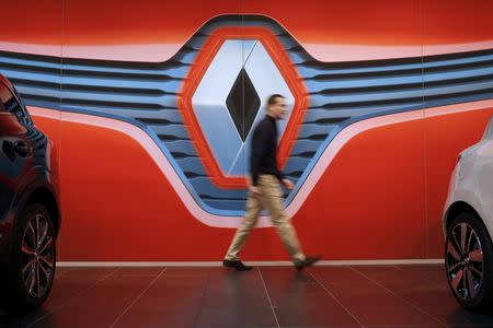 A man walks in front of a Renault logo at a dealership in Saint-Herblain near Nantes, January 19, 2016. REUTERS/Stephane Mahe